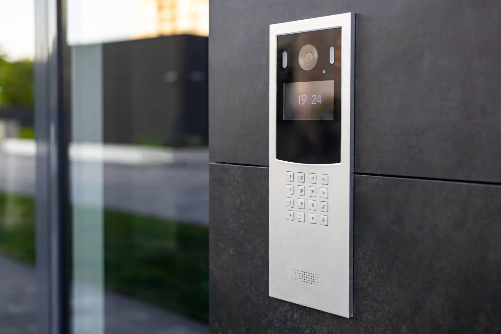 Intercom keypad mounted on exterior wall.
